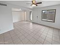 Bright living room with tile floors, ceiling fan, door and windows at 1433 N 53Rd Ave, Phoenix, AZ 85043