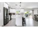 Modern kitchen featuring white cabinets, stainless steel appliances, and an island with seating at 2041 E Harvard Dr, Tempe, AZ 85283