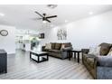 Living room with plush seating, ceiling fan, and a view into the bright kitchen at 2041 E Harvard Dr, Tempe, AZ 85283