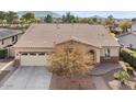 An aerial view of a single-story home with tile roof, desert landscaping, and a two-car garage at 2981 E Fandango Dr, Gilbert, AZ 85298