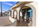 Covered front porch with arched entryway and comfortable seating at 918 S Ember Cir, Mesa, AZ 85208