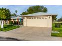 One-story home with a double garage and a well-maintained lawn at 10202 W Mountain View Rd, Sun City, AZ 85351