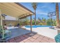 Covered patio with seating area overlooking the pool and backyard at 11024 N 81St Dr, Peoria, AZ 85345