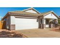 View of a white single-story house with a two-car garage and desert landscaping at 15936 W Latham St, Goodyear, AZ 85338