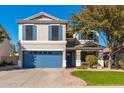 Two-story house with blue garage door and landscaped lawn at 4660 E Torrey Pines Lane Ln, Chandler, AZ 85249