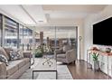 Modern living room featuring a large TV, plush sofa, and wood floors at 7151 E Rancho Vista Dr # 4001, Scottsdale, AZ 85251