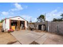 Backyard view featuring a detached shed or workshop and a paved area at 7502 W Cora Ln, Phoenix, AZ 85033