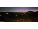 Stunning panoramic night view from a desert hillside property at 8702 E Silver Saddle Dr, Carefree, AZ 85377