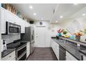 Modern kitchen featuring stainless steel appliances and dark countertops at 19777 N 76Th St # 1248, Scottsdale, AZ 85255