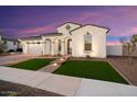 Stunning curb appeal with brick pathway and artificial turf at 20568 W Oregon Ave, Buckeye, AZ 85396