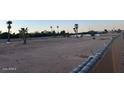 Vacant lot with sparse vegetation and chain link fence at 10420 N 64Th Pl, Paradise Valley, AZ 85253