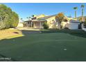 Backyard with putting green, swimming pool, and surrounding trees at 11808 N 111Th Way, Scottsdale, AZ 85259