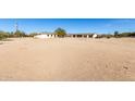 Aerial view of a property with a house, garage, and open land at 1430 W Maddock Rd, Phoenix, AZ 85086