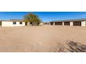 Exterior view of a home with a detached garage and desert landscape at 1430 W Maddock Rd, Phoenix, AZ 85086