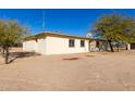 Side view of a single-story home with desert landscaping at 1430 W Maddock Rd, Phoenix, AZ 85086