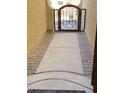 Private courtyard with decorative iron gate and paver walkway at 18169 W Cactus Flower W Dr, Goodyear, AZ 85338