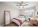 Cozy bedroom featuring a full bed, a desk workspace, and a large mirror at 2264 E Holmes Ave, Mesa, AZ 85204