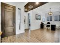 Foyer with an adjacent home office featuring a desk, chair, and shuttered window at 4711 N 212Th Dr, Buckeye, AZ 85396