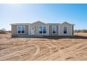 Charming single-story home with neutral exterior and ample windows at 51937 W Wildwood Rd, Maricopa, AZ 85139