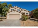 Inviting two-story home with attached two-car garage and desert landscaping at 6638 W Hughes Dr, Phoenix, AZ 85043