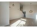 Bright and spacious living room with high ceilings and modern light fixtures at 6638 W Hughes Dr, Phoenix, AZ 85043