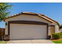 House exterior showcasing a two-car garage and neatly landscaped yard at 7005 W Cavalier Dr, Glendale, AZ 85303