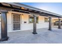 Covered front porch with decorative columns, security door, and exterior lighting at 7823 N 60Th Ave, Glendale, AZ 85301