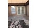 Back patio with a stone walkway and sliding glass doors at 12445 N 21St Ave # 31, Phoenix, AZ 85029
