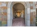 Elegant entryway with arched doorway and stone details at 2 E Biltmore Estates Dr # 115, Phoenix, AZ 85016