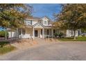 Inviting home with covered porch, mature trees, and paver driveway at 2506 E Melrose St, Gilbert, AZ 85297