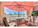 Balcony with patio furniture, umbrella, and a view of the golf course and lake at 3800 S Cantabria Cir # 1023, Chandler, AZ 85248