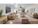 Bright living room with ample seating and large windows at 44792 W Miraflores St, Maricopa, AZ 85139