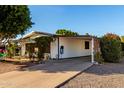 Exterior view of the home with attached carport and desert landscaping at 5502 E Baywood Ave, Mesa, AZ 85206