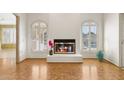 Bright living room with a fireplace and wood-look floors at 10947 W Edgewood Dr, Sun City, AZ 85351