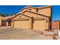 Attractive two-story home with three-car garage and desert landscaping at 11432 W Ashland Way, Avondale, AZ 85392