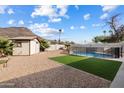 Backyard oasis with pool, shed, artificial turf, and desert landscaping at 1344 W Joan De Arc Ave, Phoenix, AZ 85029