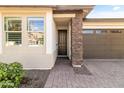 Front entry with brick columns and a modern front door at 22459 E Marsh Rd, Queen Creek, AZ 85142
