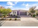 Single story home with a two-car garage and landscaping at 22459 E Marsh Rd, Queen Creek, AZ 85142