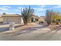 Charming single-story home with desert landscaping and attached two-car garage at 24407 S Starcrest Dr, Sun Lakes, AZ 85248