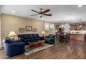 Open concept living and dining area with wood-look tile floors and a ceiling fan at 3691 E Ebano St, Gilbert, AZ 85295