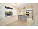 Bright kitchen with white appliances, white cabinetry, and tile flooring at 4303 E Cactus Rd # 146B, Phoenix, AZ 85032