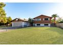 Front view of a two-story home with a landscaped yard, driveway, and attached garage at 5219 W Acoma Dr, Glendale, AZ 85306