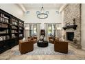 Soaring ceilings, a stone fireplace, and built-in bookshelves create a grand living room at 9424 E Hidden Spur Trl, Scottsdale, AZ 85255