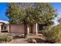 Front view of a house with a tan garage door and landscaping at 131 N Del Pueblo Pl, Chandler, AZ 85226