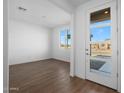 Bright entryway with modern door and wood-look tile flooring at 14835 W El Cortez Pl, Surprise, AZ 85387