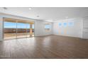 Bright living room with tile floors and sliding glass doors leading to backyard at 14835 W El Cortez Pl, Surprise, AZ 85387