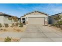 Single story home with a two car garage and front yard landscaping at 17352 W Country Club Ter, Surprise, AZ 85387