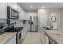 Modern kitchen with stainless steel appliances and granite countertops at 17352 W Country Club Ter, Surprise, AZ 85387