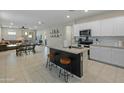 Open concept kitchen with island, stainless steel appliances, and white cabinets at 17352 W Country Club Ter, Surprise, AZ 85387