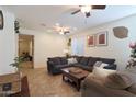 Spacious living room featuring a sectional sofa and tile floors at 2135 N Heritage St, Buckeye, AZ 85396